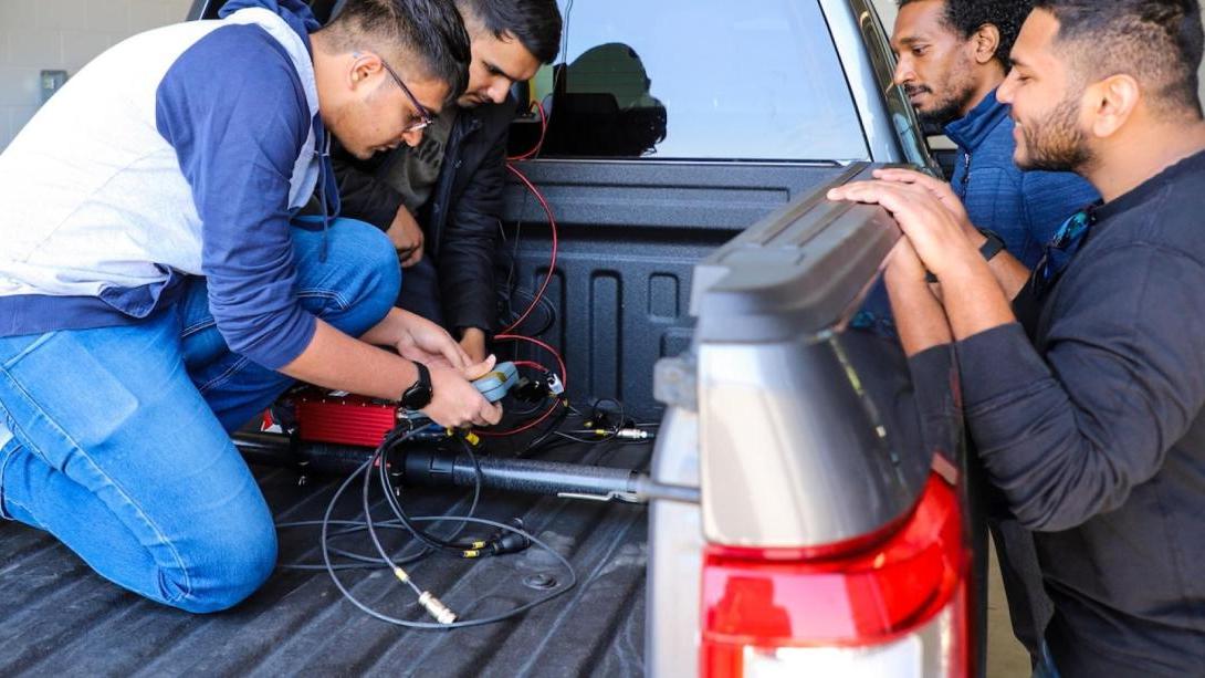 Graduate students brake testing vehicle