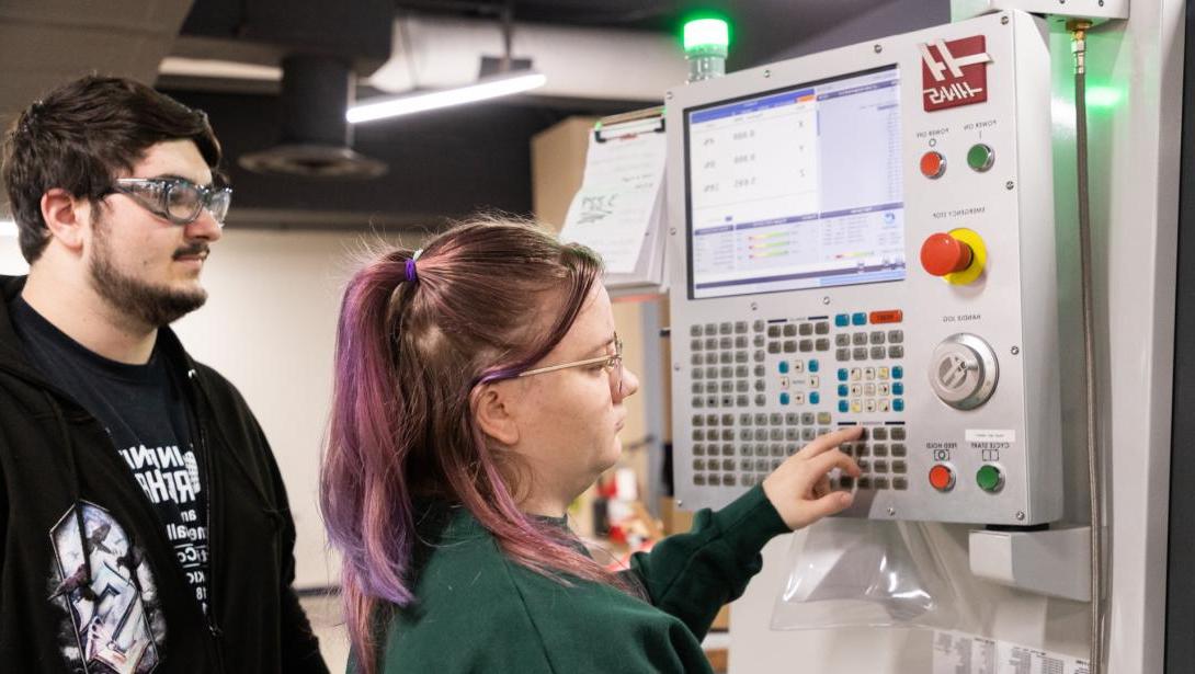 Two students working with equipment