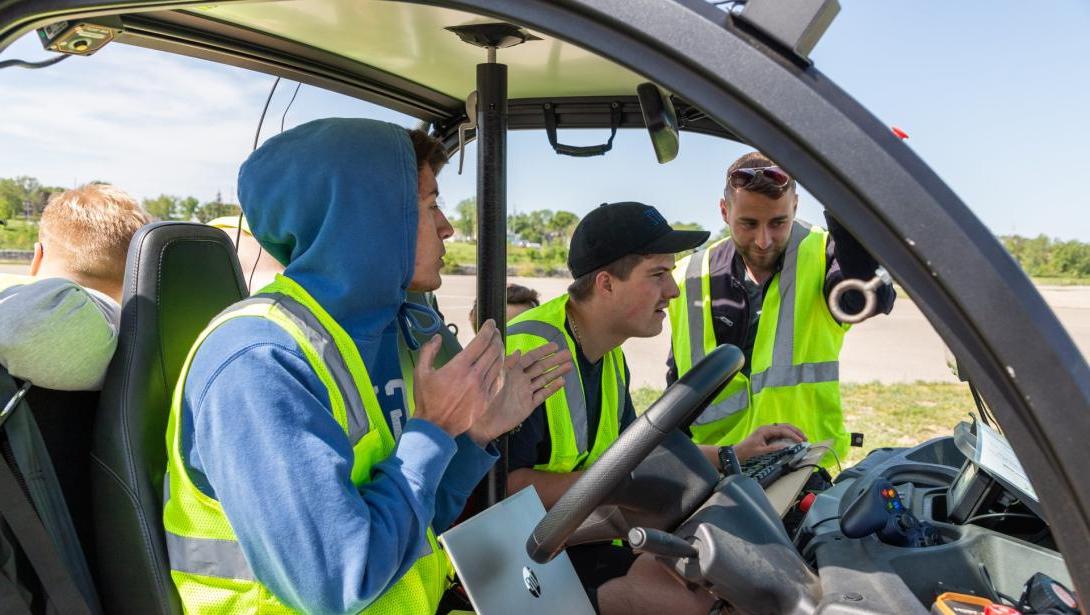 Students working in a model vehicle